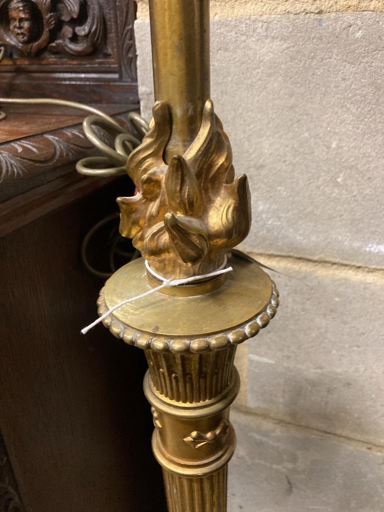 An adjustable gilt standard lamp and a pair of corinthian column lamps